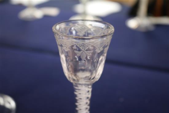 A cordial glass, c.1760, with fan cut fleur de lys engraved fluted bowl, multi-series opaque twist stem, 5.5in.